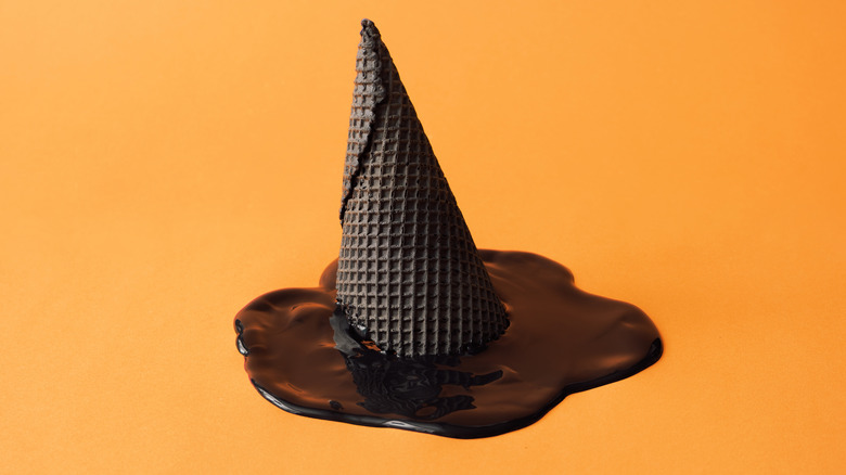 A black ice cream cone and melted black ice cream