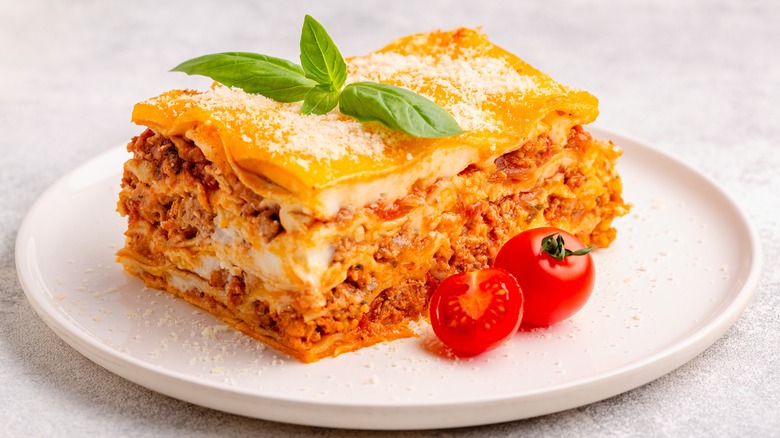 Big slice of lasagna garnished with basil