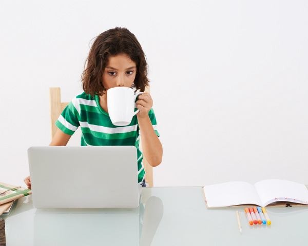 Cute kid sipping from a mug