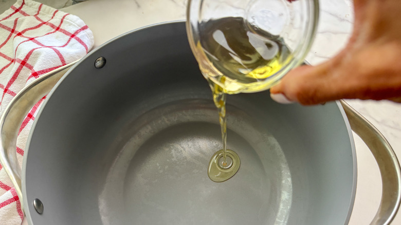 adding oil to pot