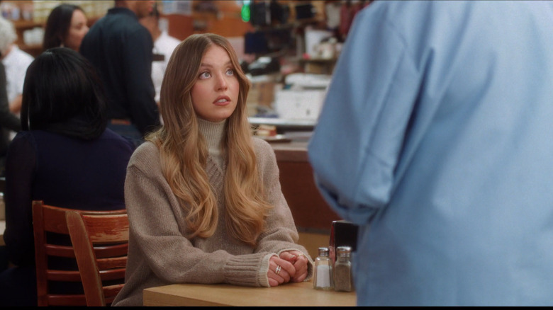 Sydney Sweeney at a table at Katz's deli in NYC shoot for Hellmann's commercial.