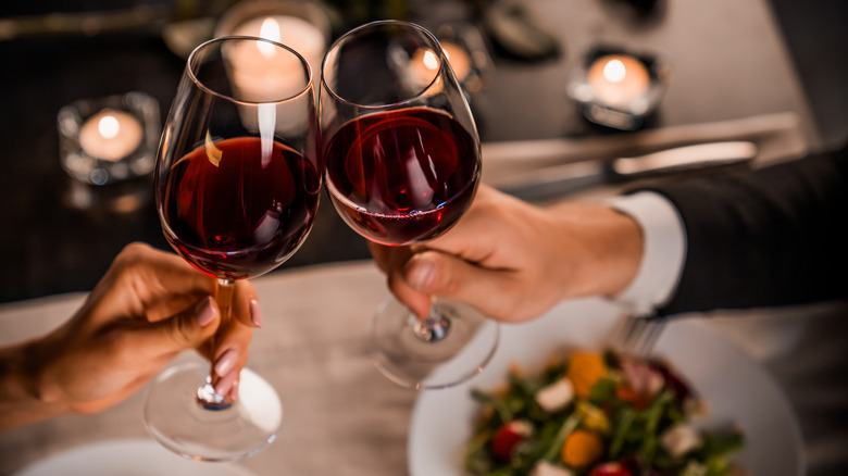 Toasting with wine glasses over a romantic dinner
