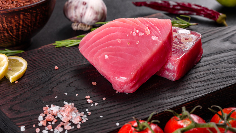 fresh tuna steaks on a cutting board
