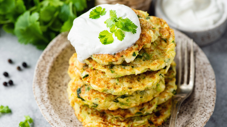Sour cream on stack of fritters