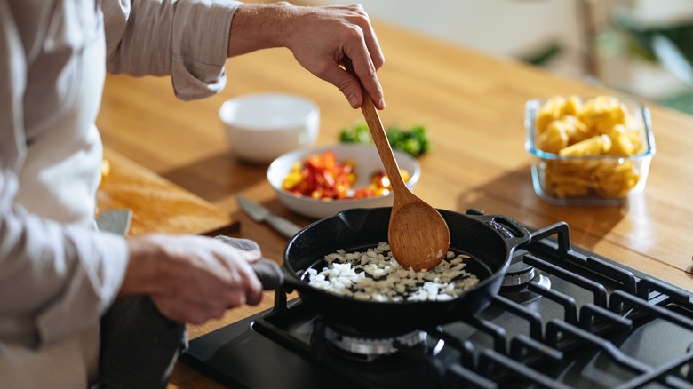 Cook stirring onions in a skillet