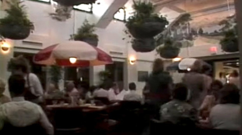 White 1980s Olive Garden interior with hanging plants and red-and-white light fixture
