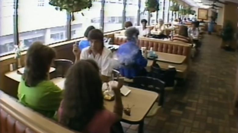 Customers eating in 1980s McDonald's solarium
