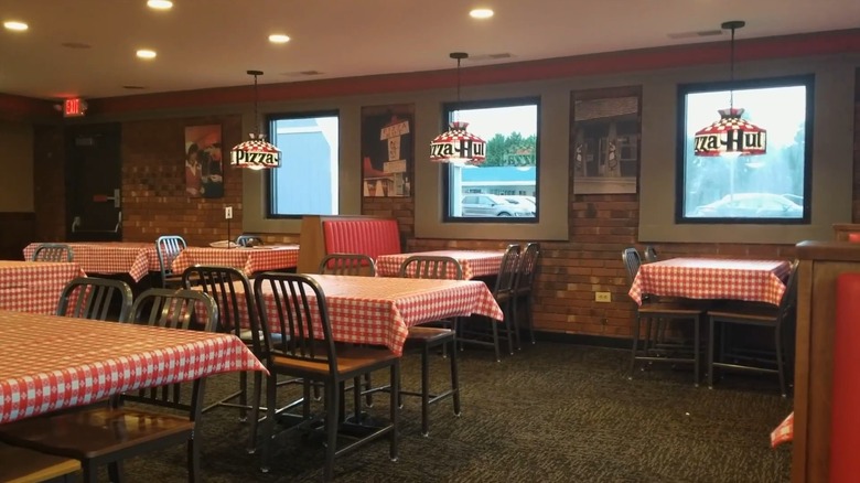 Interior of preserved '80s Pizza Hut with checkered tablecloths and Tiffany-style lamps