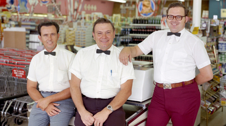 Grocery store clerks 1970s wearing white shirts and black bow ties