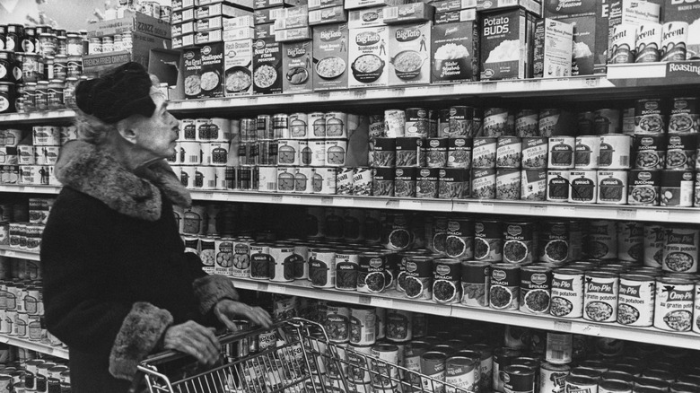 Woman shops for pre-packaged food in a grocery store