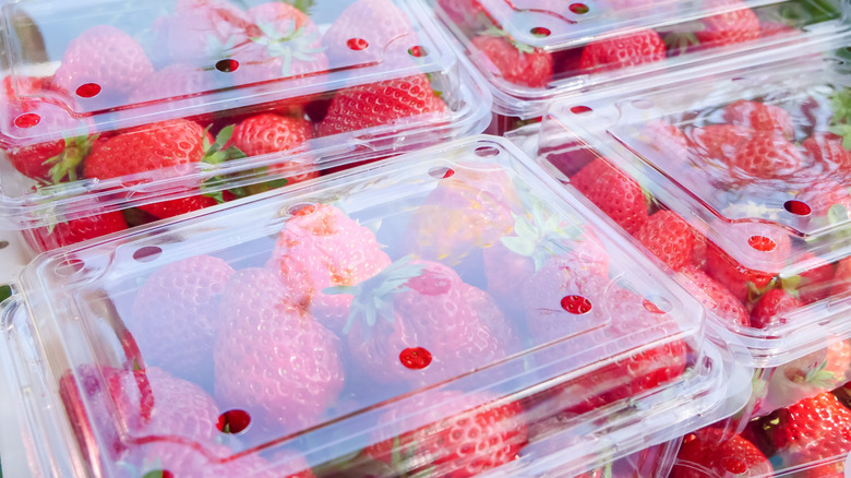 Boxes of fresh strawberries in vented clear plastic clamshell packaging