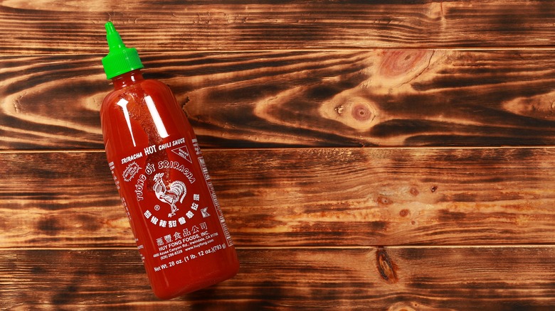 Sriracha on wooden table 