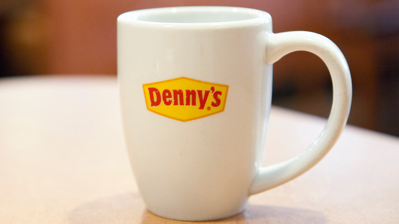 White Denny's mug on a table