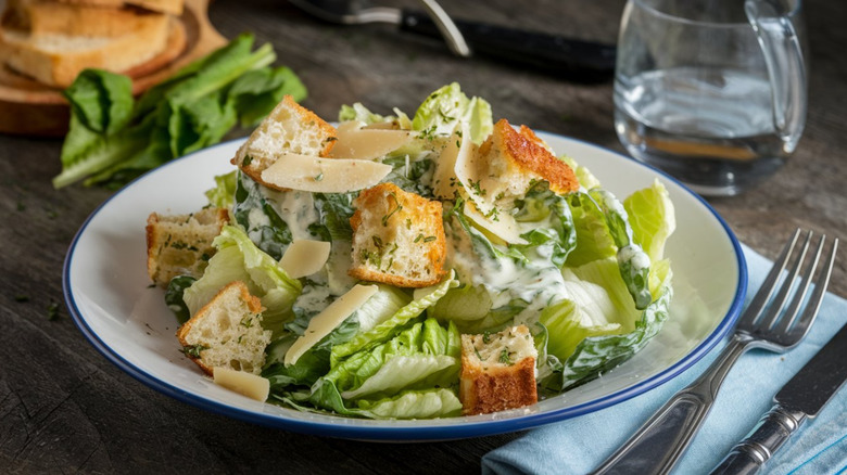 A Caesar salad with croutons on top