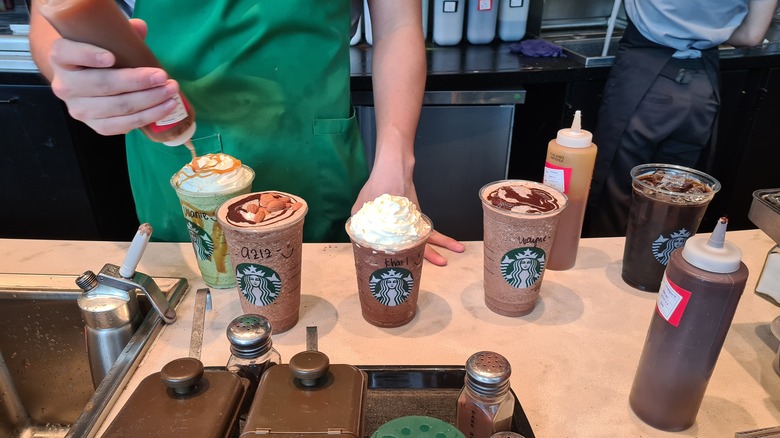 Several Starbucks drink orders on counter