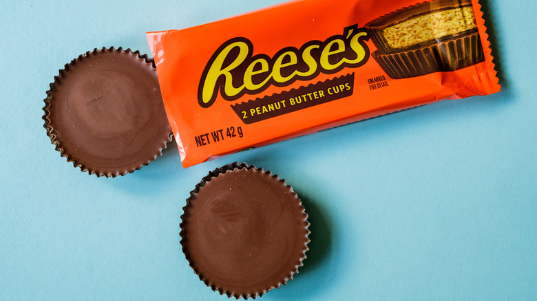 A pack of Reese's Peanut Butter Cups with two cups out