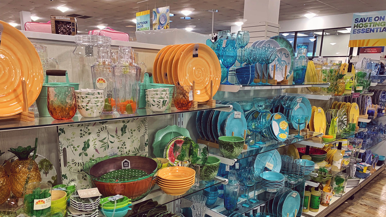 Shelves at HomeGoods full of colorful dinnerware