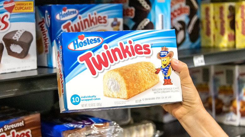 Someone picks a box of Twinkies off a shelf