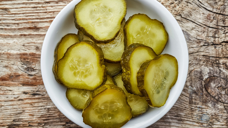 bowl of sliced pickles on table