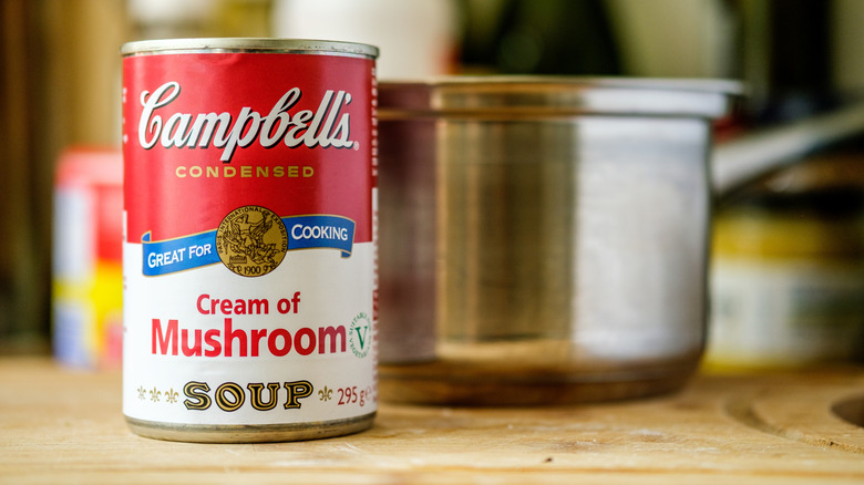 Can of Campbell's cream of mushroom soup with stainless steel pot