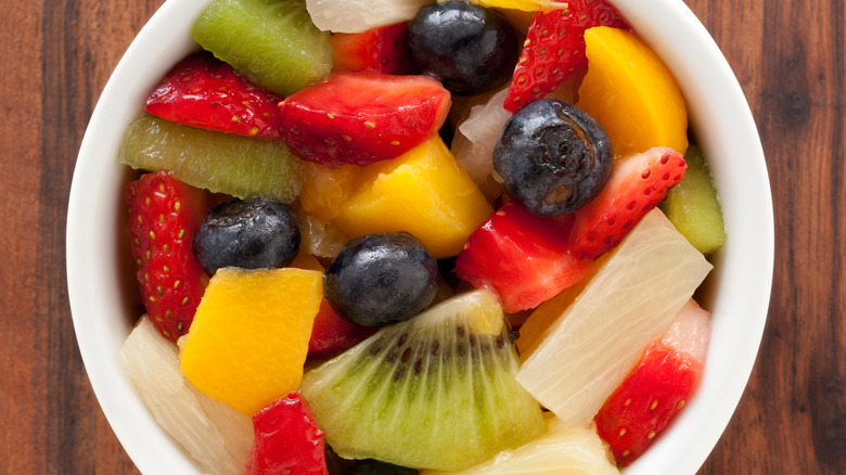 Bowl of fruit salad on wooden table