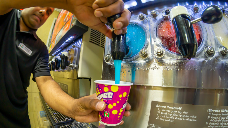 person filling Slurpee cup