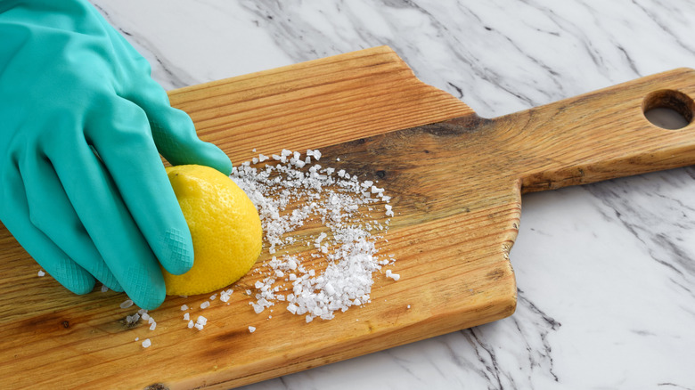 Cutting board with salt and a halved lemon