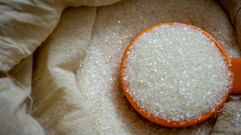 Bag of sugar with measuring spoon