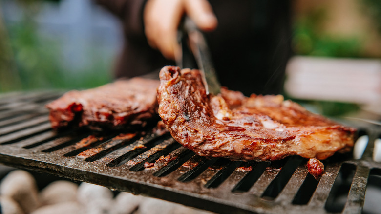 Person grilling steak