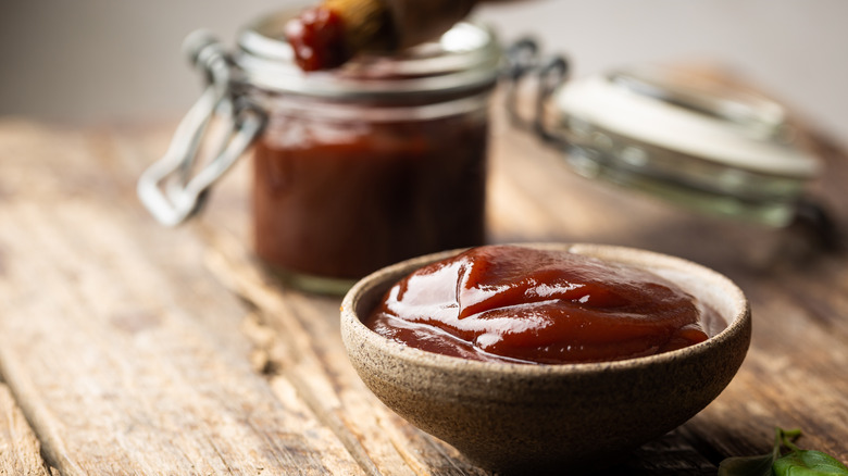 cup and jar of barbecue sauce 