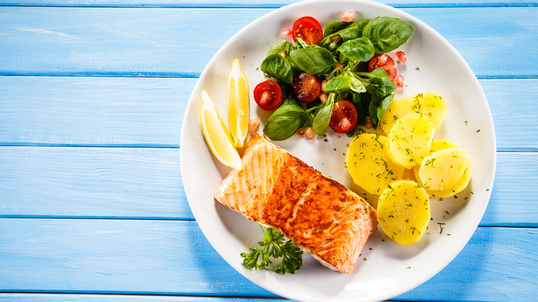 plate of salmon, potatoes, and salad