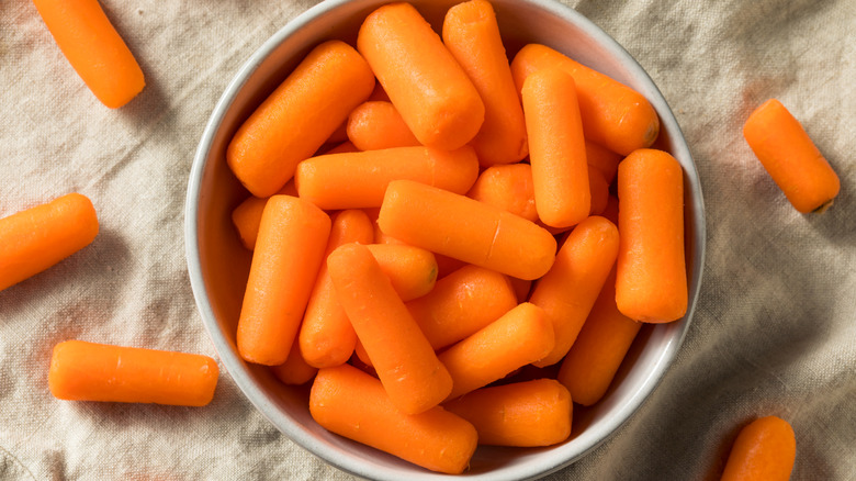 Baby carrots in a white bowl