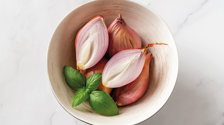 White bowl holding cut shallots
