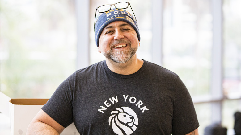 Duff Goldman smiling in New York shirt and glasses