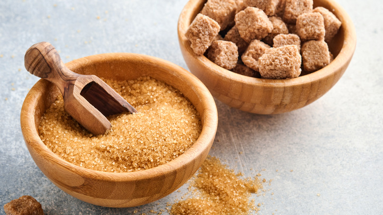 Bowls of brown sugar granules and brown sugar cubes