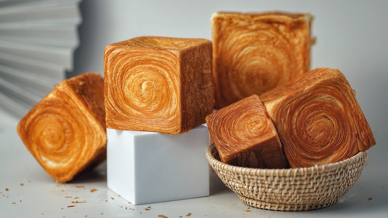 Multiple cube shaped croissants displayed on countertop