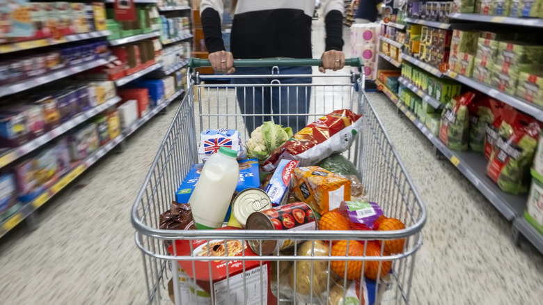 grocery cart filled with food staples