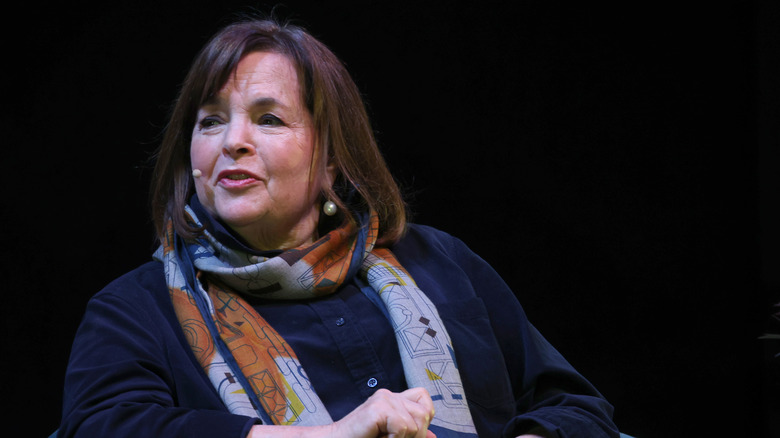 Ina Garten seated on stage with microphone headset
