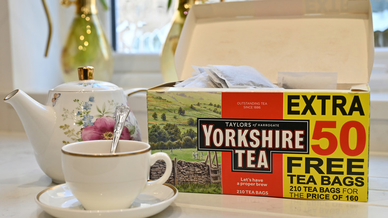 Box of Yorkshire tea setting next to a tea cup