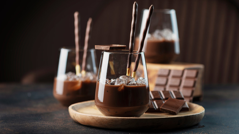 Glasses of chocolate liqueur with chocolate and chocolate sticks