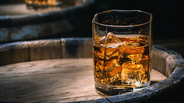 Glass of whiskey on a barrel