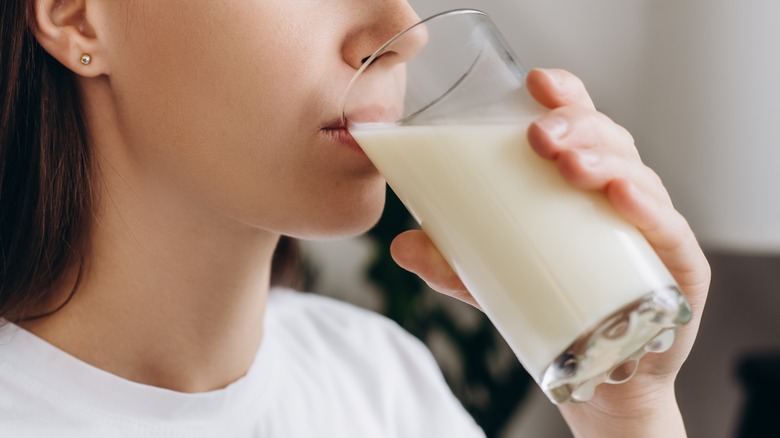 Person drinking glass of milk