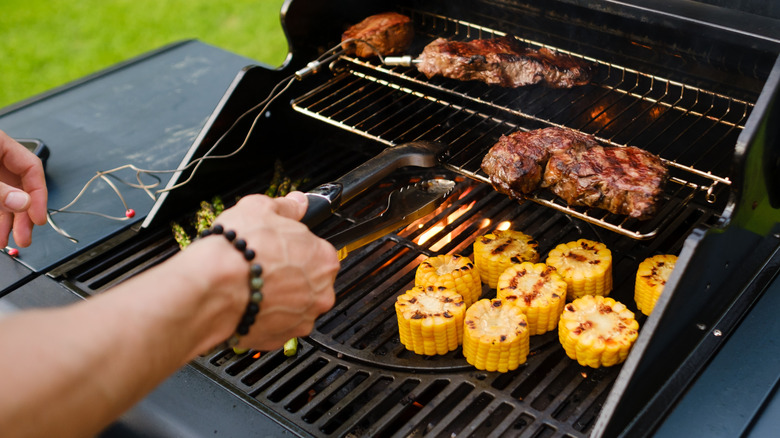 Hands of a person grilling
