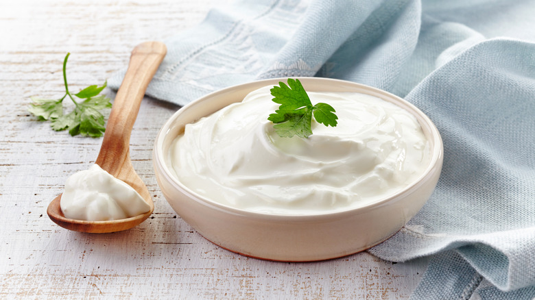 Sour cream in bowl with parsley