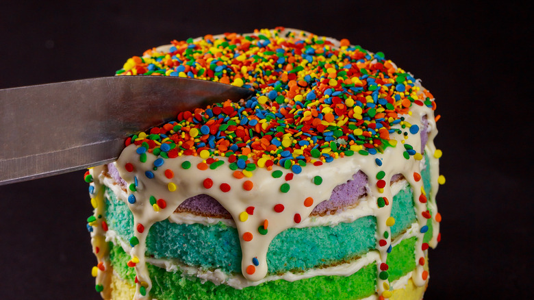 Knife cutting into cake