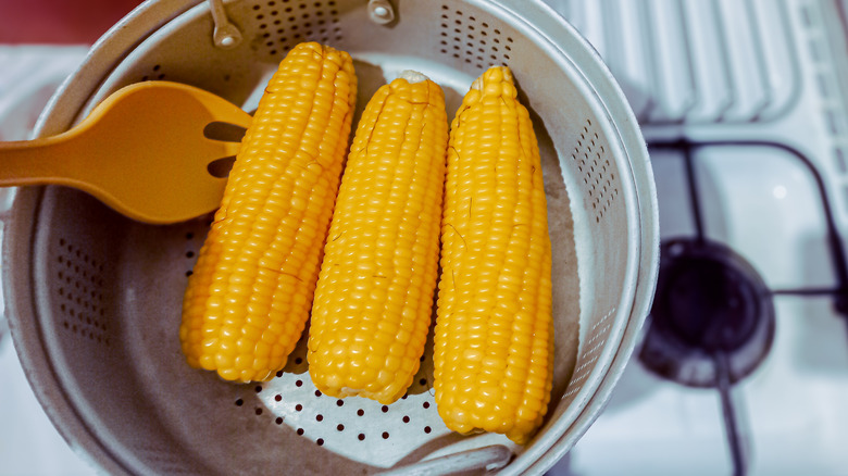 Three ears of corn in pot strainer