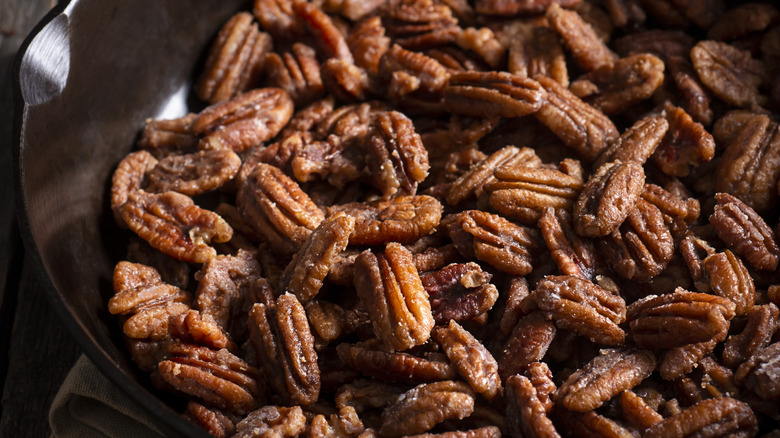 A skillet filled with candied pecans