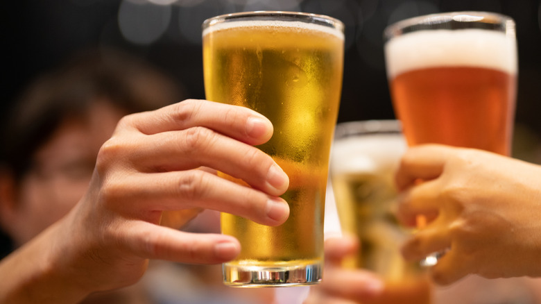 Hands lifting up glasses of beer