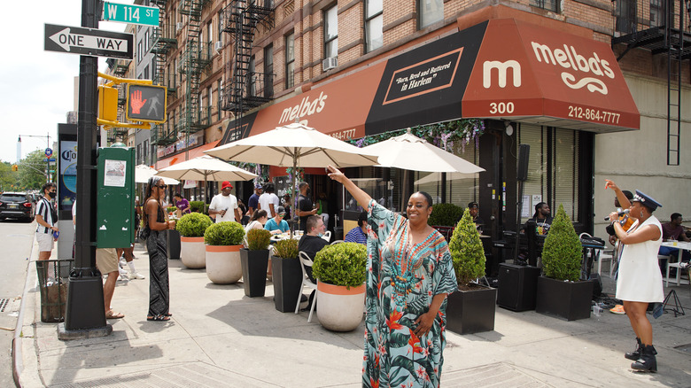 Melba Wilson indicating street sign