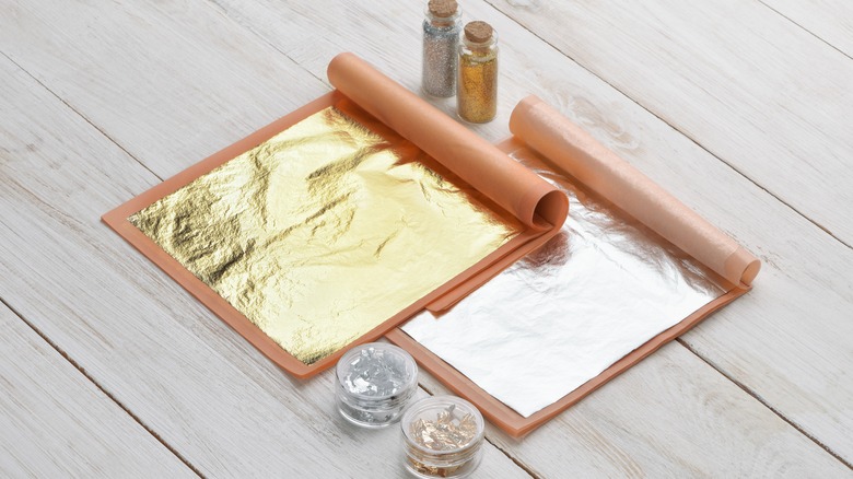 Edible gold and silver leaf with gold and silver flakes in containers